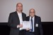 Dr. Nagib Callaos, General Chair, giving Prof. Rolf Dornberger the best paper award certificate of the session "ICT Applications in Science and Engineering." The title of the awarded paper is "The Time Diagram Control Approach for the Dynamic Representation of Time-Oriented Data."